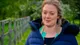 Rosie Brandreth-Poynter by a wooden fence outside the tent, in a blue padded coat, mid-sentence
