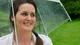 Sophie Faldo under a clear umbrella in the rain, smiling, just named Star Baker